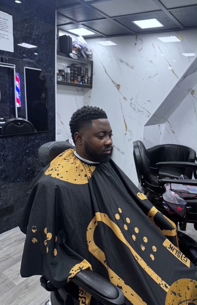 Short fade with a shaped, lined-up beard.